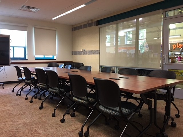 Mount Airy small meeting room with a long rectangular table and conference-style seating