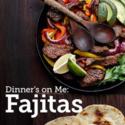 Skillet of fajita fillings and tortillas on a wooden tabletop
