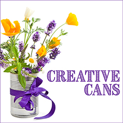 Empty metal can tied with purple ribbon and filled with flowers