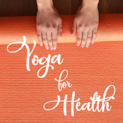 Hands rolling an orange yoga mat