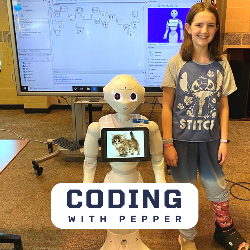 Pepper the Robot with a young girl in front of a computer screen with coding