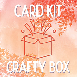 Line drawing of an open box with confetti popping out and the words card kit crafty box in white over a watercolor warm leafy background