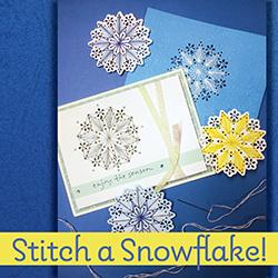 Cardstock and stitched snowflakes over a blue paper background