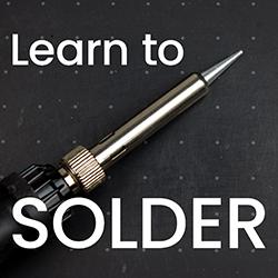 Soldering iron on a black background