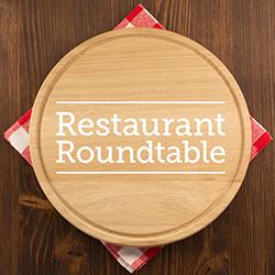 Round wooden plate on red checkered napkin resting on table