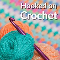 crochet hook and bright colored yarn