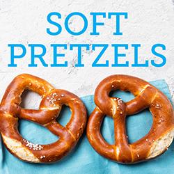 Soft pretzels on blue background