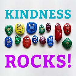 Several painted multicolor rocks with happy, goofy faces.