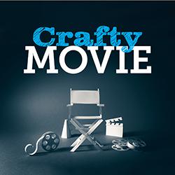 A cut paper movie set in white including a director's chair, clapper, and other movie items over a dark background