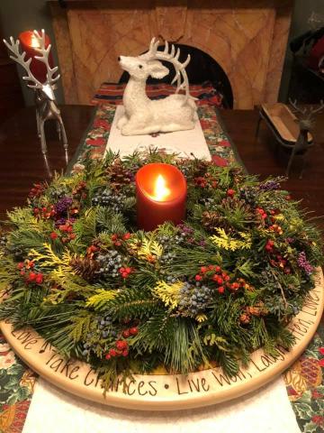 Fresh wreath centerpiece with candle.