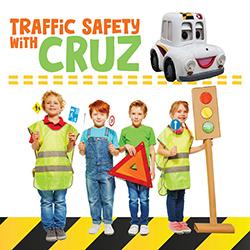 Four kids dressed in oversized yellow safety vests holding an orange warning triangle and a cardboard traffic light