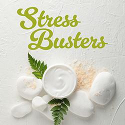 Homemade facial scrub in a white bowl surounded by fern fronds and minerals