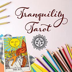 Drawing paper with coloring pencils and a tarot card deck on top