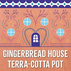 a colorful gingerbread house decoration on a terra-cotta background