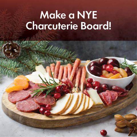 Charcuterie on wooden tray with pine needles in background. Text: Make an NYE Charcuterie Board!