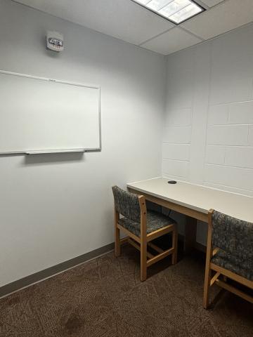 North Carroll Tutor Room with seating for two and a whiteboard.