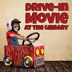 a child wearing sunglasses and a helmet in a cardboard car