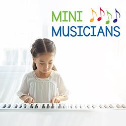 Little girl in a white dress playing a piano seen from the front
