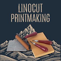 Linocut supplies (printing blocks, brayer, cutters) over a mountain peak linocut illustration with a navy blue background.