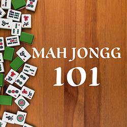 Assorted Mah Jongg tiles on the left of a wooden tabletop seen from above.