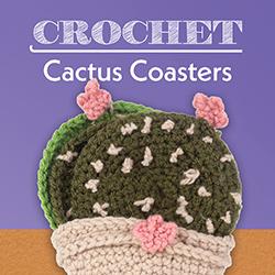 A beige crocheted flower pot coaster holder with green cactus pad coasters inside. Cactus pads have pink blossoms.
