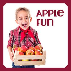 a child holding a crate of apples