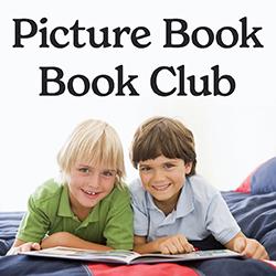 two young boys reading a book together