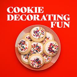 A plate of sprinkle cookies on a red background seen from above.