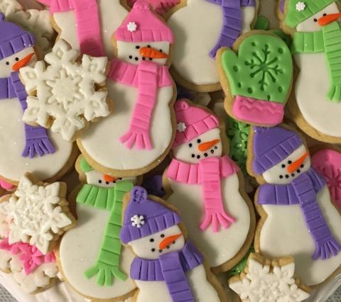 snowman, mitten, and snowflake cookies decorated with multiple colors of fondant