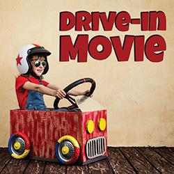 Child in a cardboard car with "DRIVE-IN MOVIE" text on the wall.