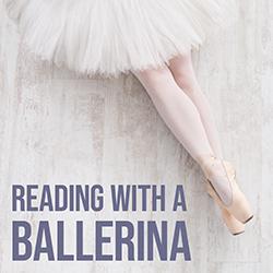 A ballerina sitting on a neutral colored floor showing her tutu, legs, and shoes viewed from above