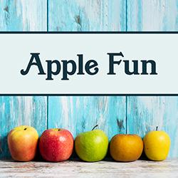 a variety of apples in front of a blue wooden background