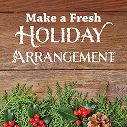 Fresh cut holiday greens and cranberries on a wooden tabletop