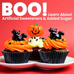 A plate of artificially flavored chocolate Halloween cupcakes with orange icing