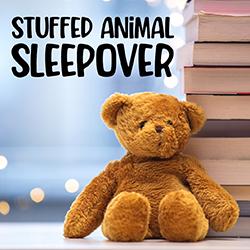 a stuffed bear leaning against a stack of books