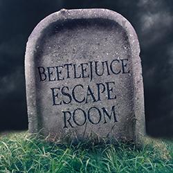 A headstone with Beetlejuice Escape Room engraved on it in front of a dark cloudy background