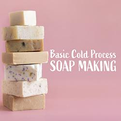 A stack of handmade soap bars on a pink background