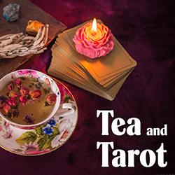 a deck of tarot cards with a candle on top next to a cup of tea