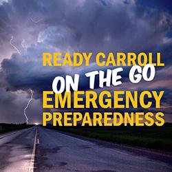 View down a 2-lane road to a large thunderstorm with lightning