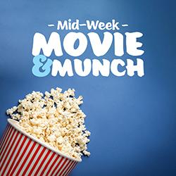 A spilled red-striped popcorn bucket over a blue background seen from above