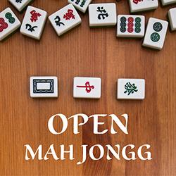 Mah Jongg tiles arranged on a wooden tabletop seen from above.