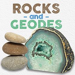 A stack of three smooth pebbles and a green geode over a white background.