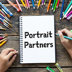 hands drawing, blank paper and colorful pencils on wooden table