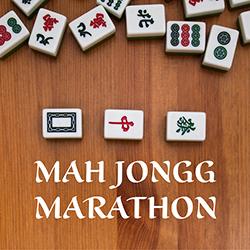 Mah Jongg playing tiles on a wooden board seen from above.