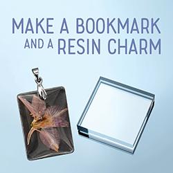 A clear acrylic block and an acrylic charm over a pale blue backgound.