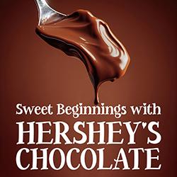 Chocolate melting off a spoon in front of a chocolate background.