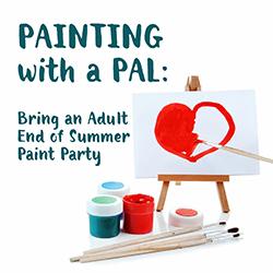 A red heart painted on a small canvas on an easel with paints and brushes below.