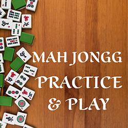 Mah Jongg tiles arranged on a wooden tabletop seen from above.