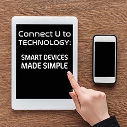 A tablet and a phone seen from above on a wooden table.